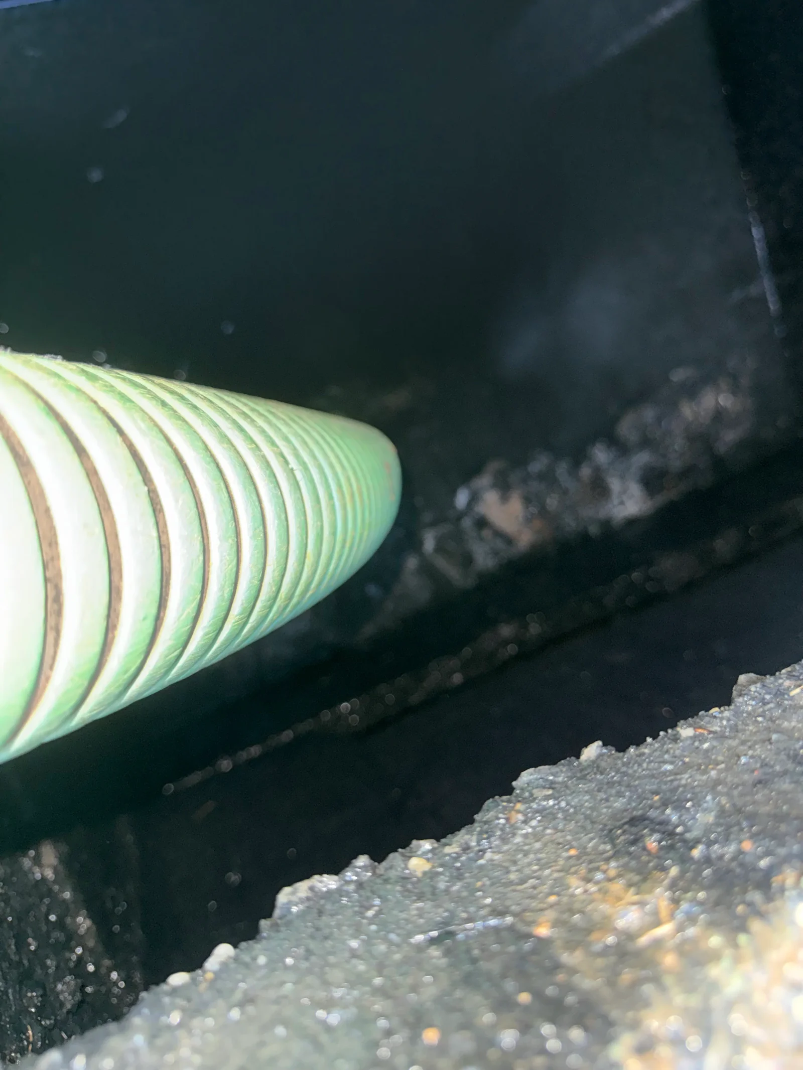 Corrugated plastic septic drain pipe with ribbed construction during underground system inspection